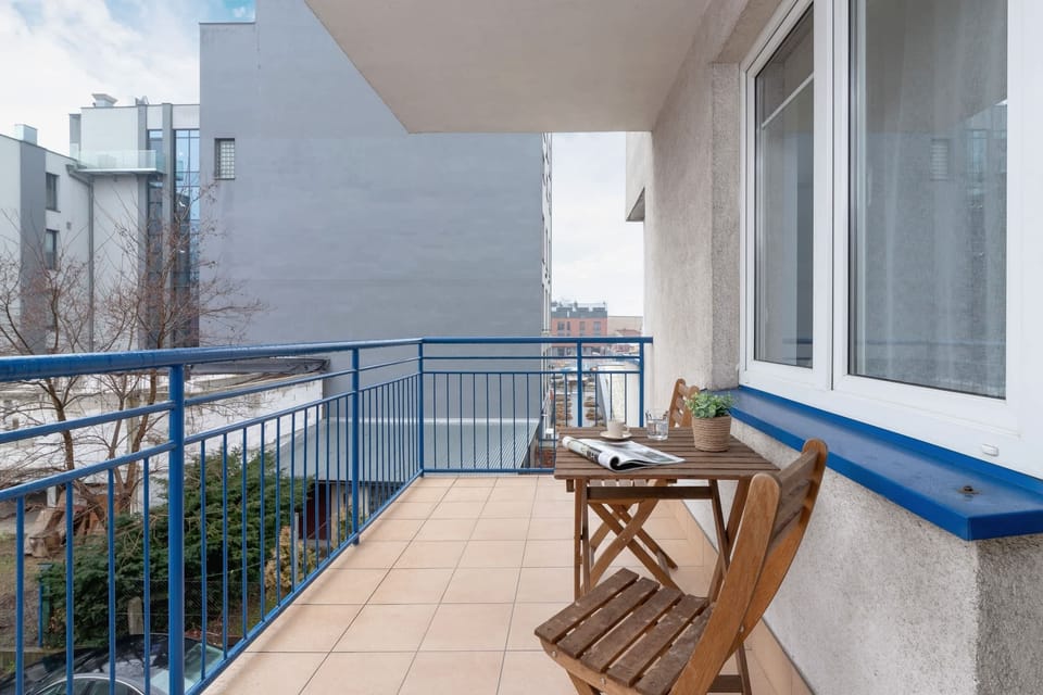 A balcony with a wooden bench and views of the surrounding area.

