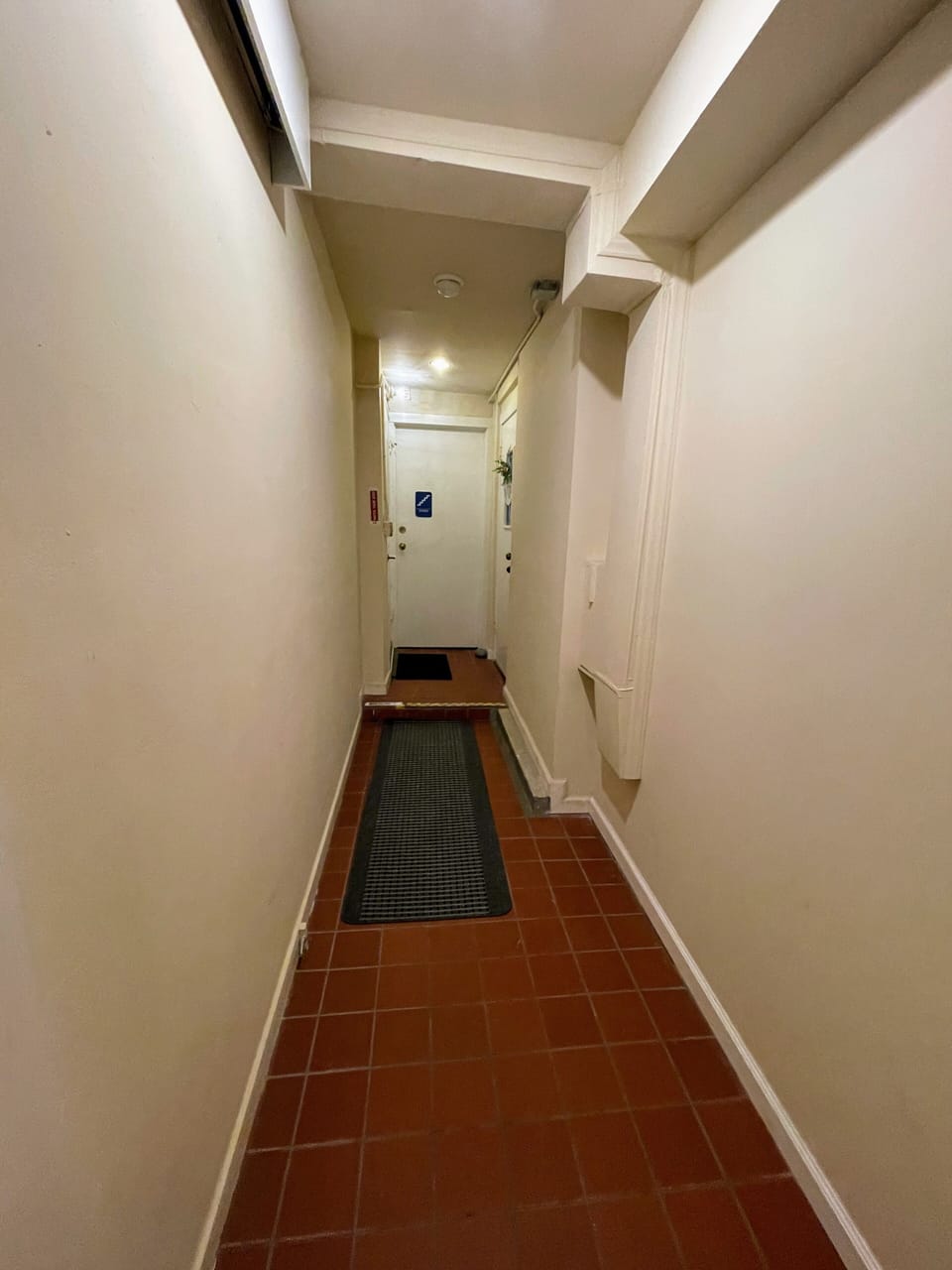Hallway with warm tones and overhead light
