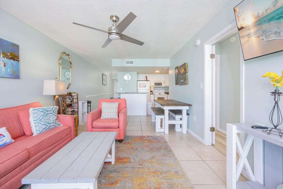 Sink into the sofa with queen sleeper, enjoying laughter with family and the inviting beach vibe of your living space