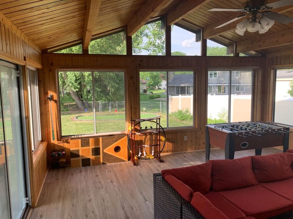 Four season porch with foosball table and plenty of seating space to gather and watch something on the 50` Roku Smart TV.