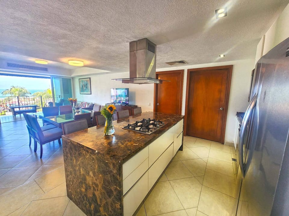 Deluxe Condo | Private kitchen | Full-size fridge, microwave, oven, blender