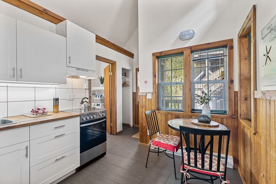 Modern stove and a cozy bistro table.