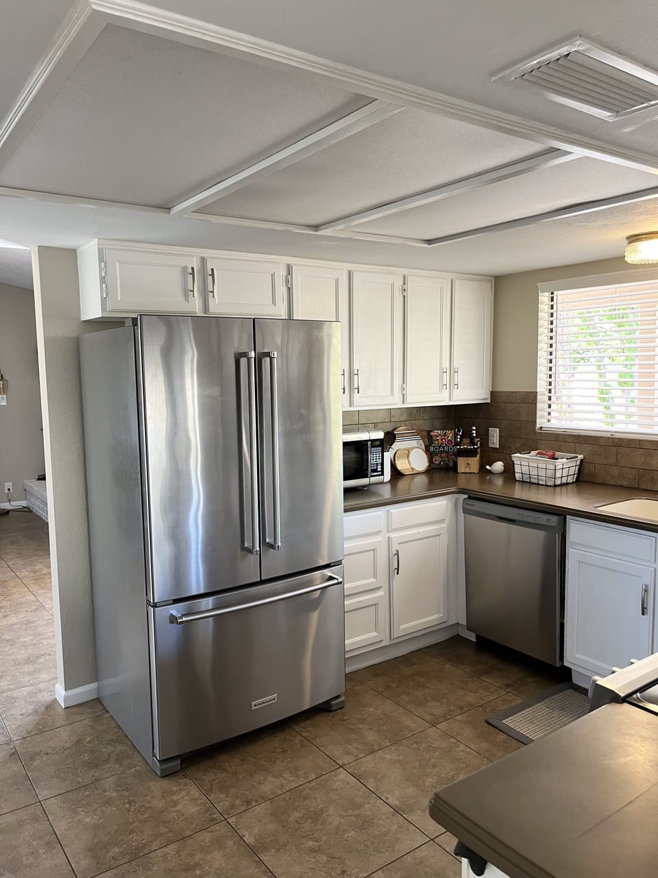 Family sized fridge with built in filtered water, new dishwasher and microwave