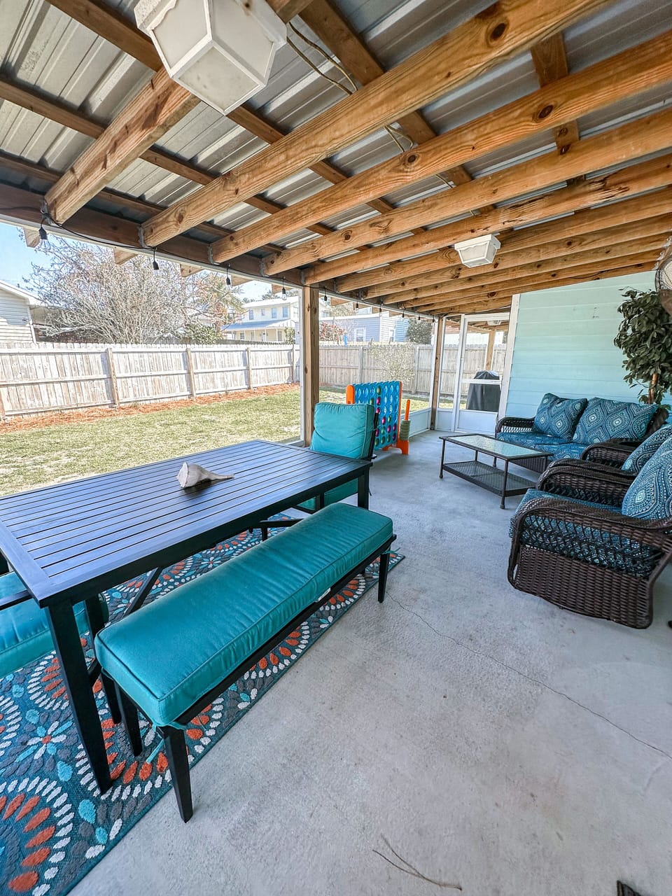 Screened in lanai with yard games and propane grill. 