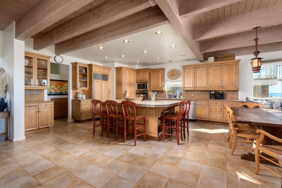 Chef`s Kitchen with Built in Refrigerator and Stainless Steel Appliances