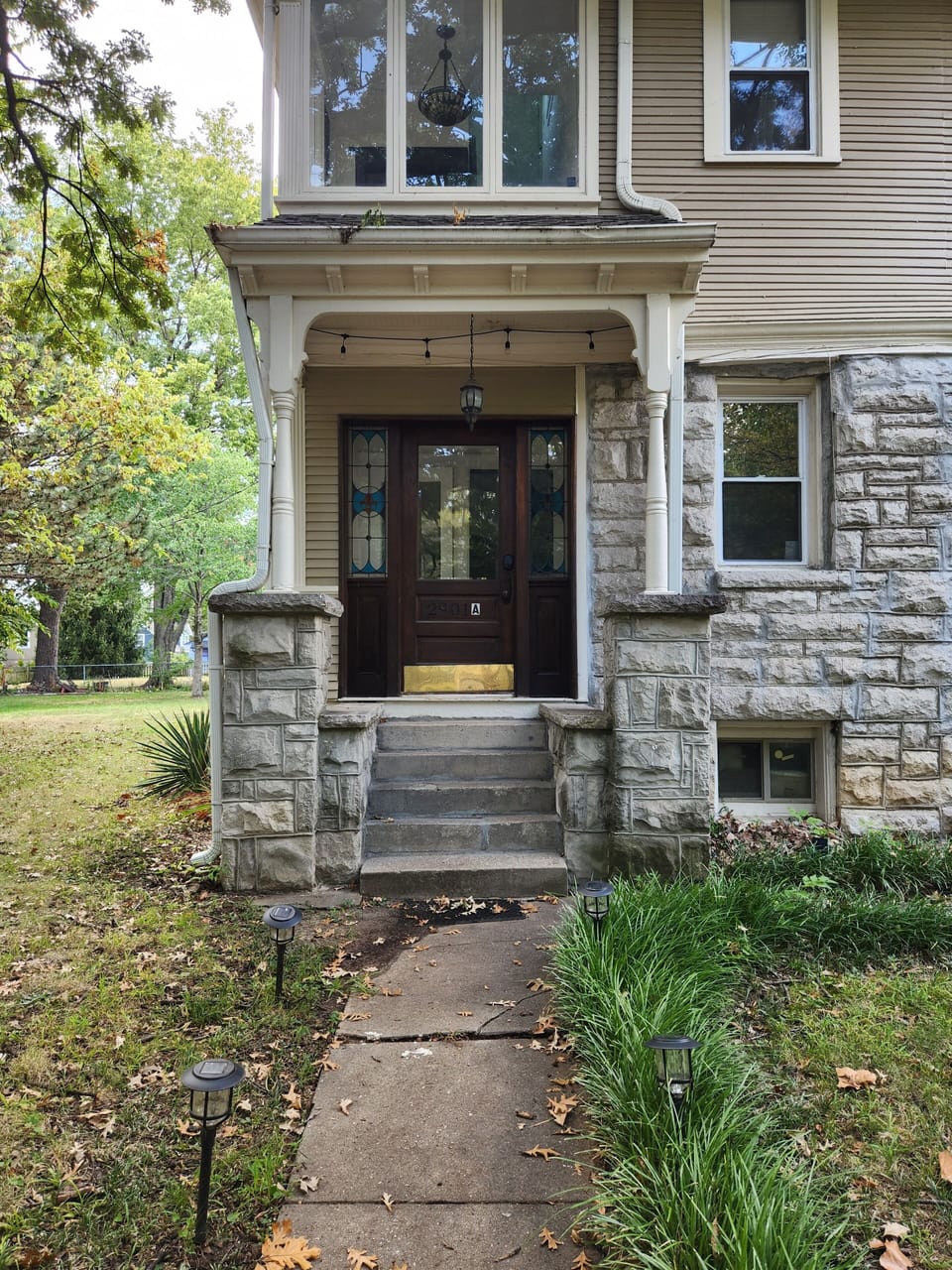 Entrance to unit has a well-lit walkway with several steps.