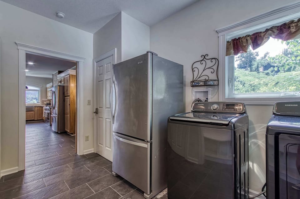 A bright and functional laundry room equipped with modern appliances makes extended stays a breeze. Thoughtfully designed for comfort and convenience.