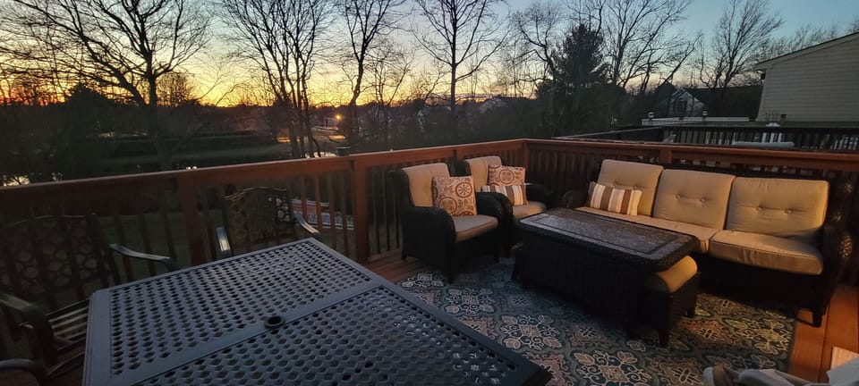 Beautiful deck with comfy cushioned chairs overlooking the pond with fountain 