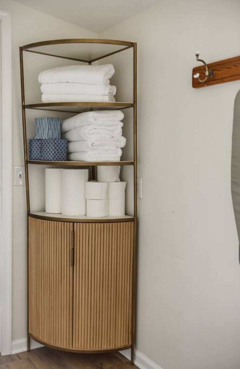 Cabinet inside laundry room with extra towels, toilet paper & paper towels.