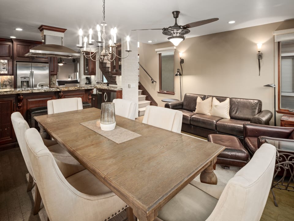 Elegant open-concept living space with cozy seating area with a leather sofa, perfect for relaxation.