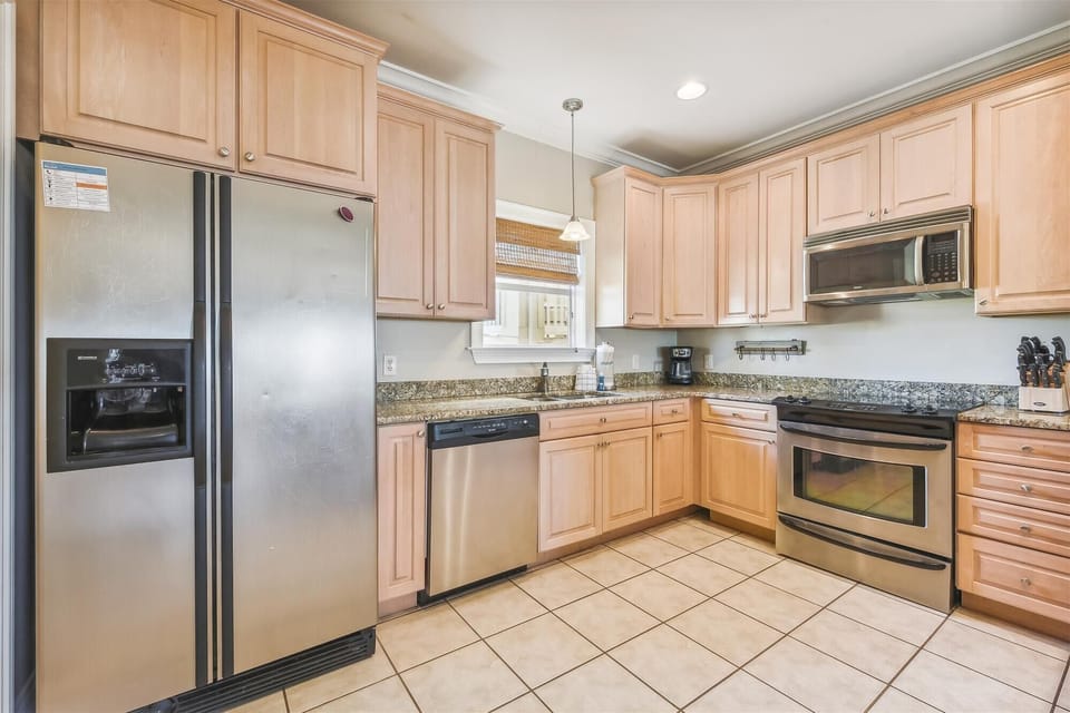Full Size Kitchen with Stainless Steel Appliances and Bar Seating
