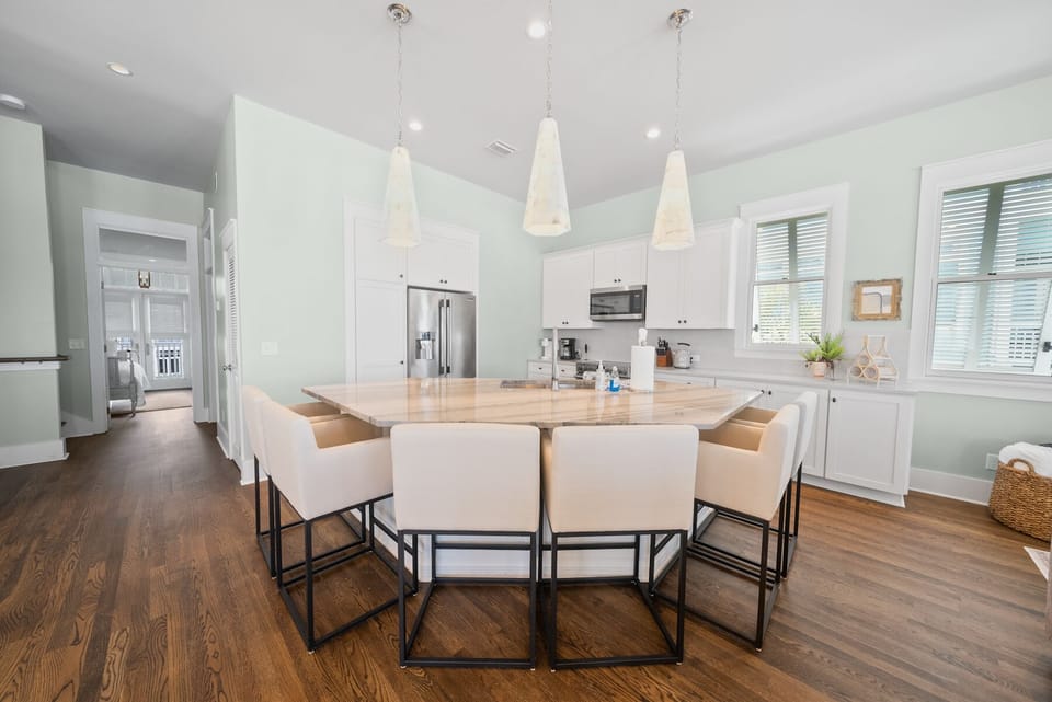 Cook and connect in this bright kitchen featuring a spacious island, modern appliances, and pendant lighting perfect for memorable meals together.