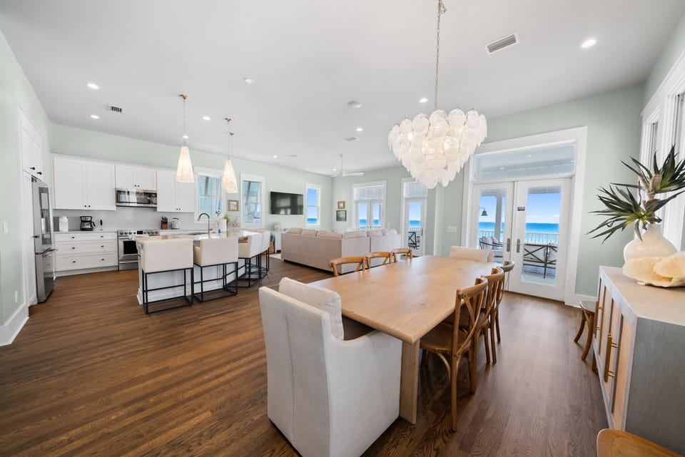 Stunning open-concept space where you'll gather for memorable meals while enjoying ocean views through floor-to-ceiling windows.