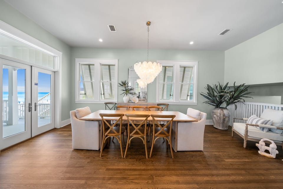 Gather around your elegant dining table with stunning ocean views streaming through French doors to your private balcony.