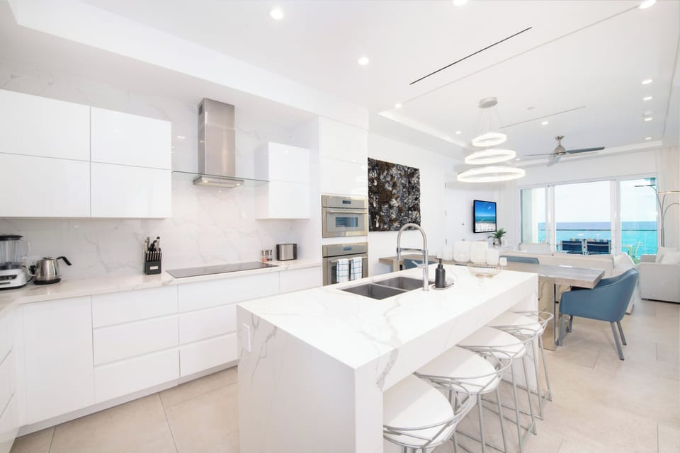 Fully stocked kitchen with gourmet appliances and island seating. 