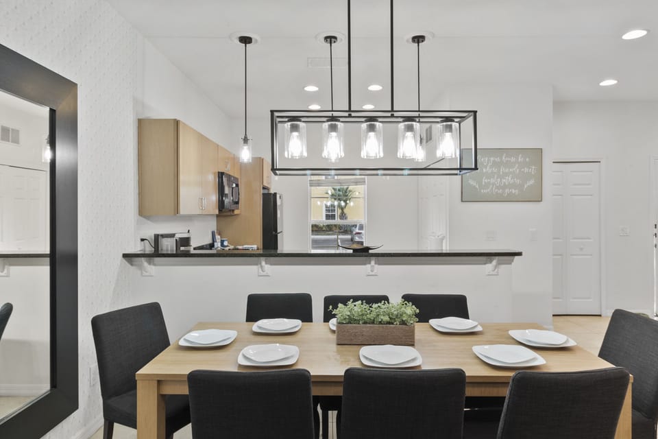Fusion of Elegance and Warmth: Stunning Dining Area Overlooking Spacious Living Room for Memorable Family Gatherings.