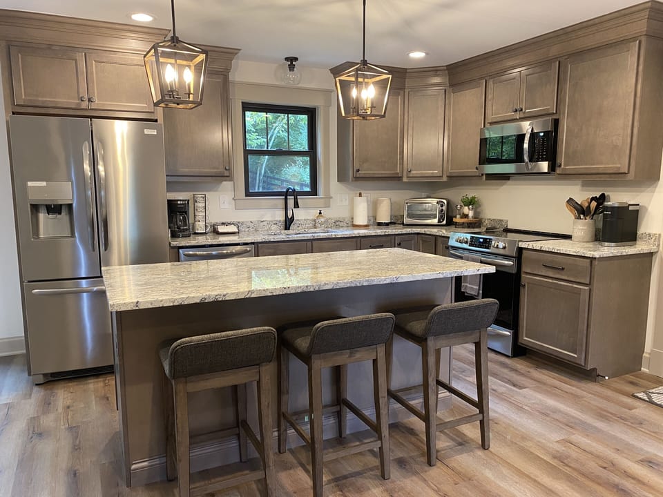 3 seats at the kitchen island and 4 seats at the table in adjoining dining area