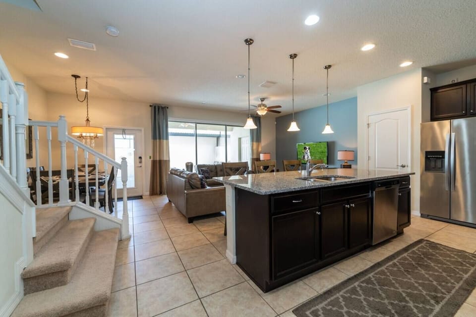Spacious Downstairs Living Area with Comfortable Sofa, Full Size Kitchen, and Dining Area