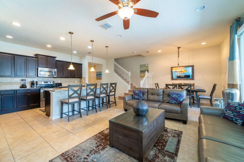 Spacious Downstairs Living Area with Comfortable Sofa, Full Size Kitchen, and Dining Area