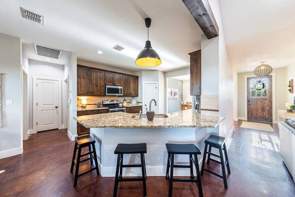 Kitchen is open to living room with seating for 4