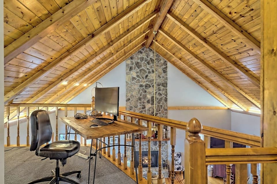 Loft area desk  with monitor and showing off those beautiful vaulted ceilings!