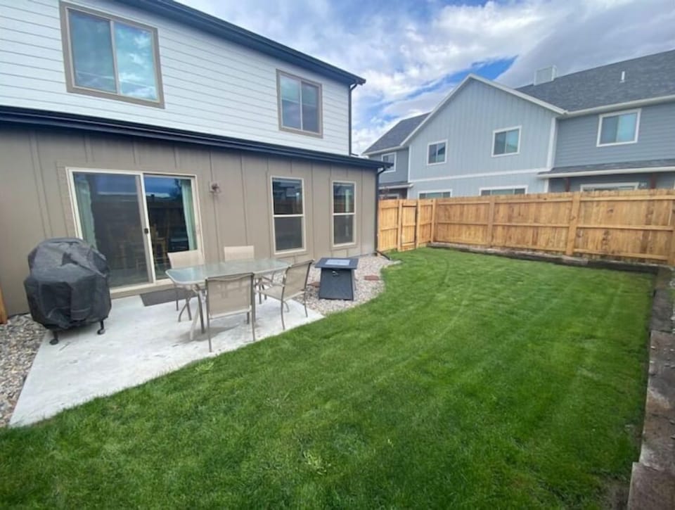 Backyard with barbecue and gas firepit.