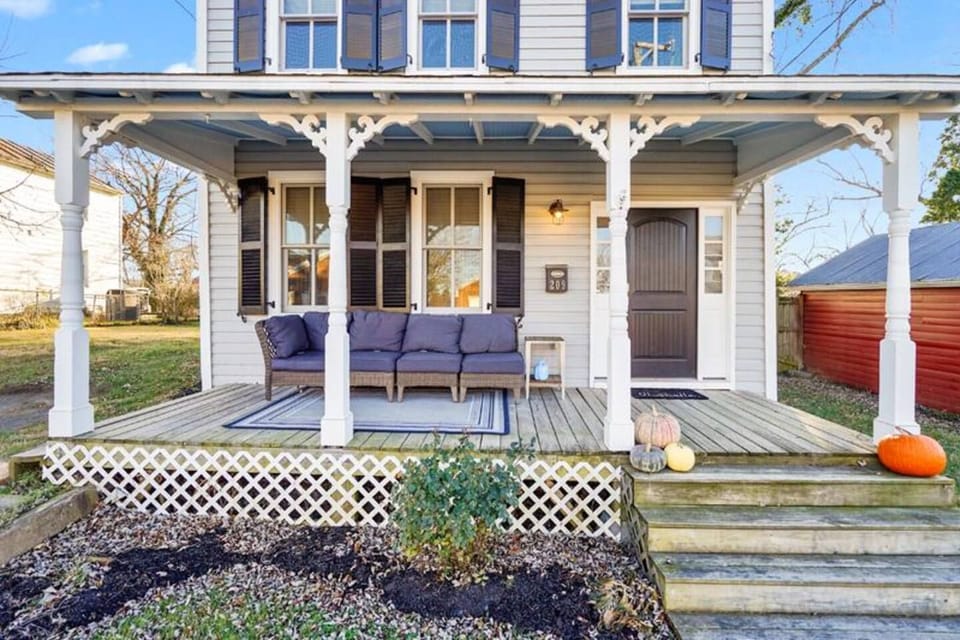 Covered front porch with comfy seating — perfect for morning coffee