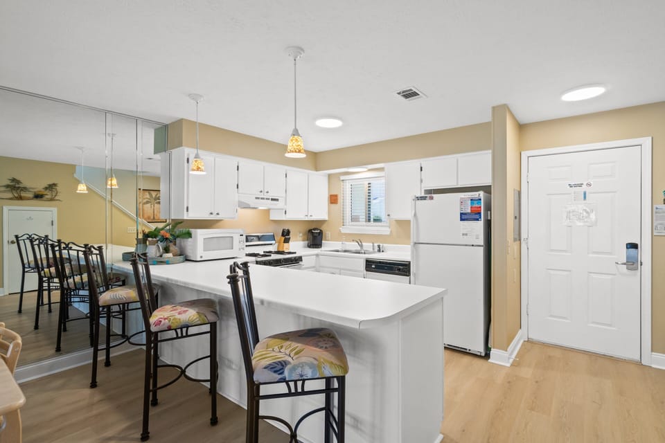Fully Stocked Kitchen with Island Bar Seating