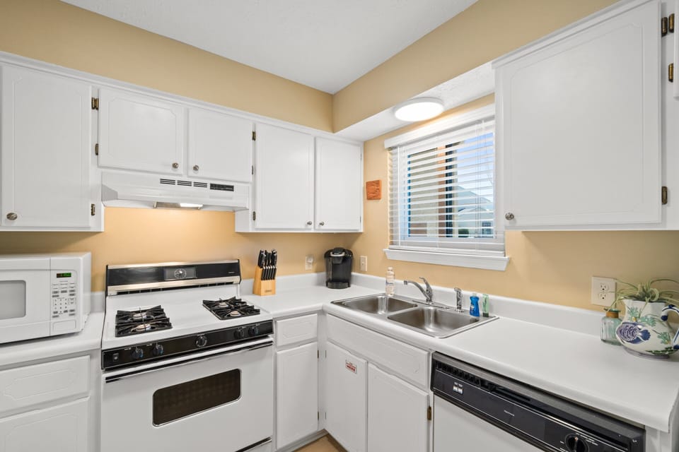 Fully Stocked Kitchen with Island Bar Seating