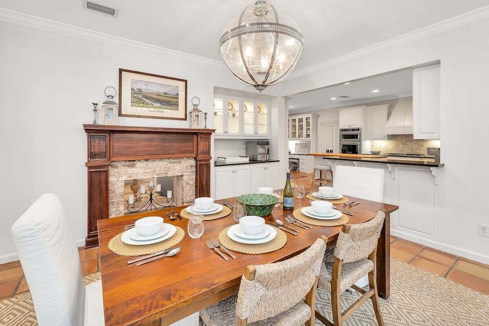 Alternate view of dining area with a stone fireplace