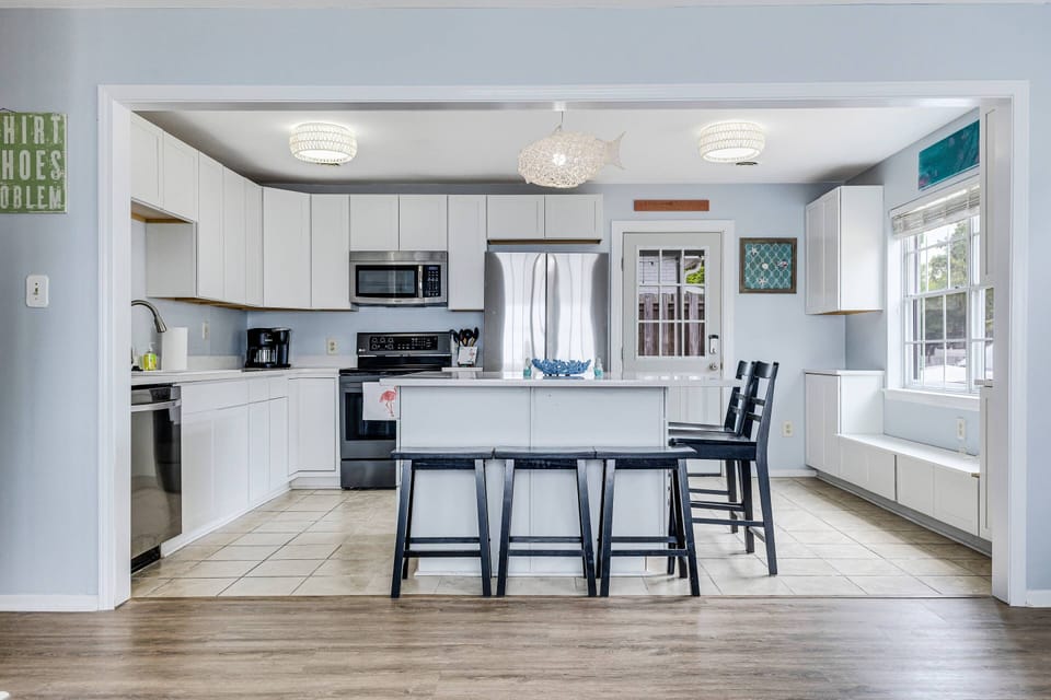 Entrance from the Screened Porch to the Laundry (left), Kitchen & Dining (Right), Living Area beyond the Kitchen.