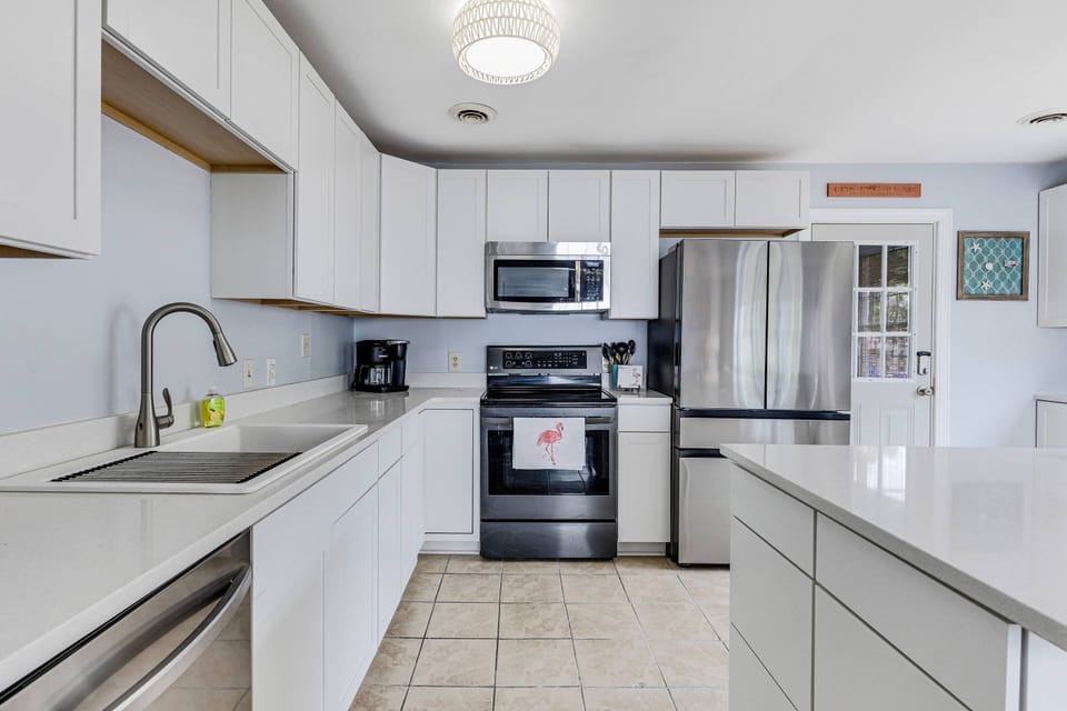 The Kitchen has a Microwave, Drip/K-Cup Coffee Maker, Electric Frying Pan, 2 Gallon Drink Dispenser & Large Pantry for Groceries.