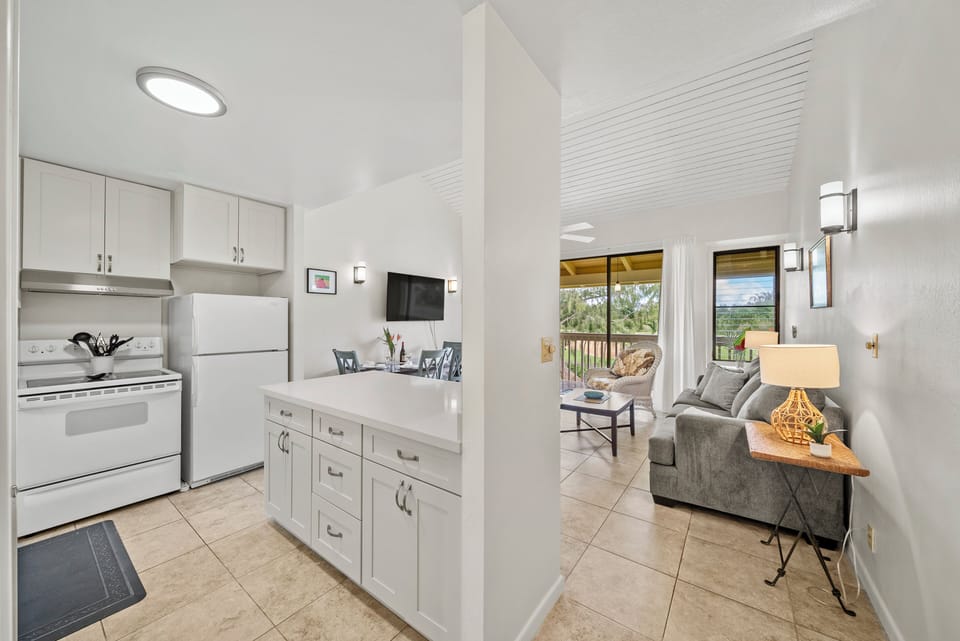 Enjoy the open view from the kitchen to the lanai while preparing meals or chatting with friends—perfect for staying connected during your stay.