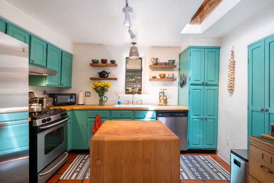 A kitchen with turquoise cabinets.
