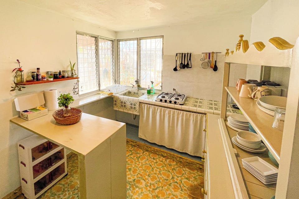 Full-size fridge, coffee/tea maker, blender, cookware/dishes/utensils