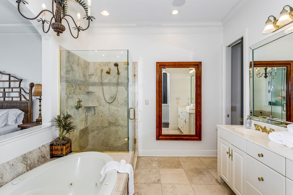 Maranatha House Master Bedroom with a Balcony tub and shower.