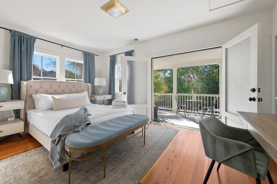 Bedroom 1: Queen bedroom featuring an en-suite bathroom, private balcony, and dedicated workspace.