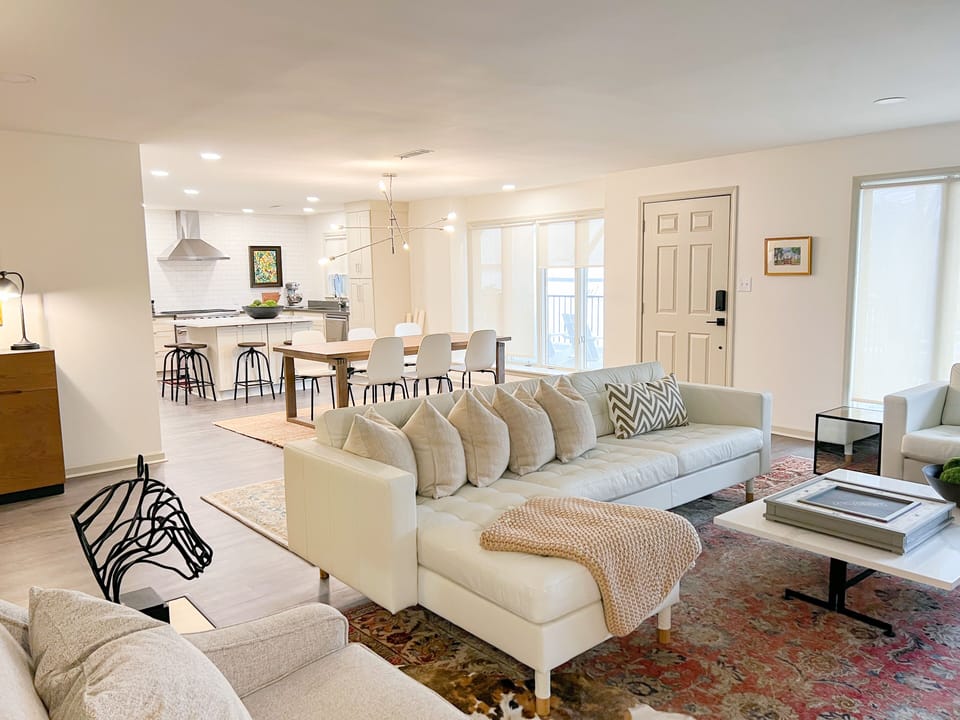 Spacious living room with smart TV, Sofa, love seat and two chairs.