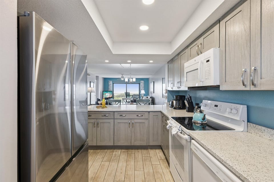 Modern kitchen with stainless steel appliances and an open layout.