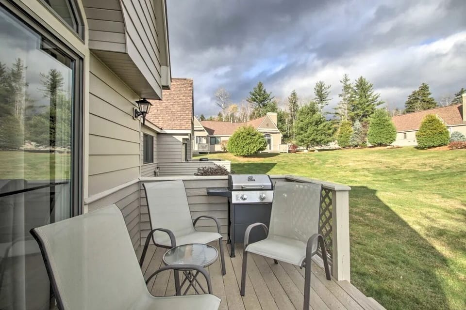 Back deck offers outdoor seating, propane grill and walk-on access to the lawn.