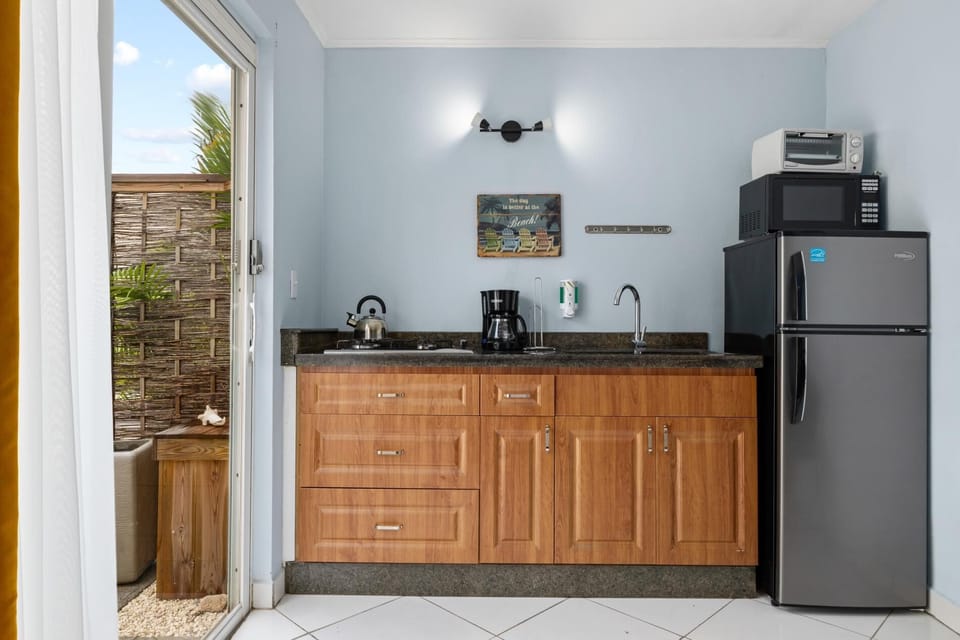 Full-size fridge, toaster oven, microwave, coffee maker and kettle as well as all the dishes, cutlery, pots and pans you might need.