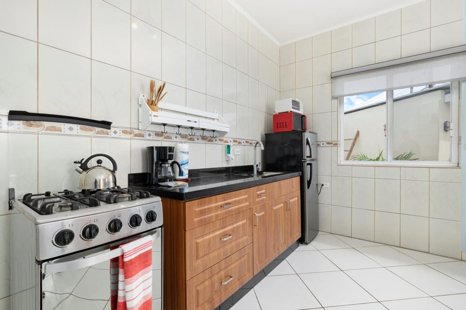 The kitchenette includes a fridge, range, toaster oven, microwave and coffee machine.
