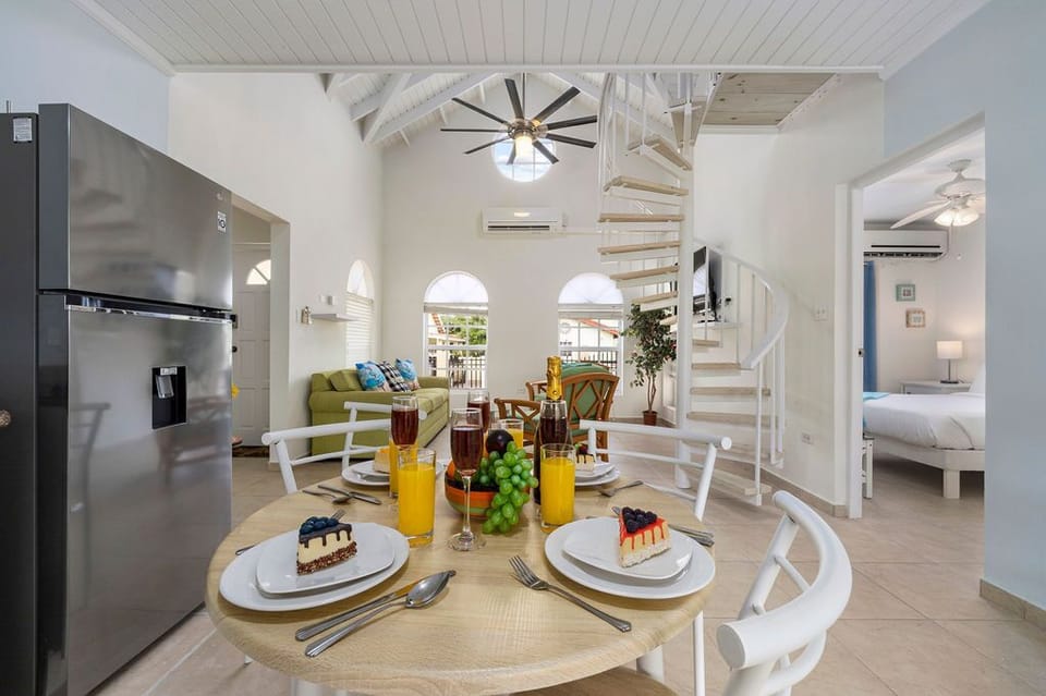 This home has an open floor plan that links the living room and kitchen areas. Four people can eat at the table.