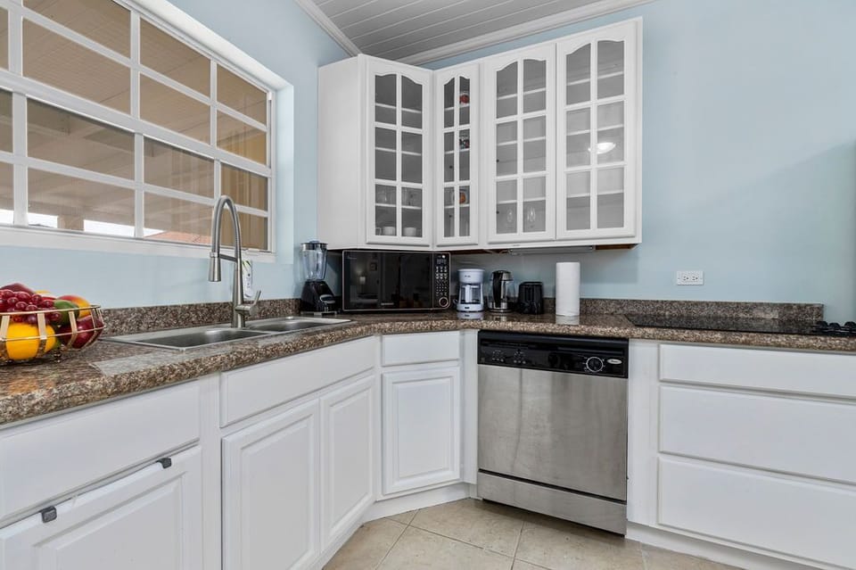 The kitchen comes with a fridge, dishwashers, a cooktop, a microwave oven, a coffee maker blender, and enough storage for your groceries.