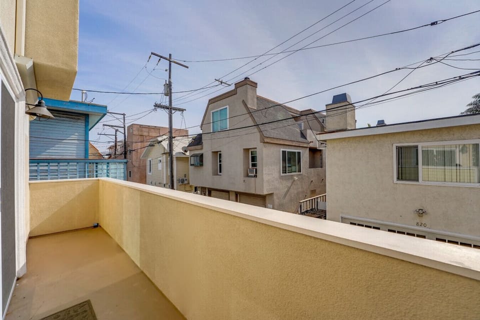 Balcony off the main living area with two large slider doors and a propane grill.