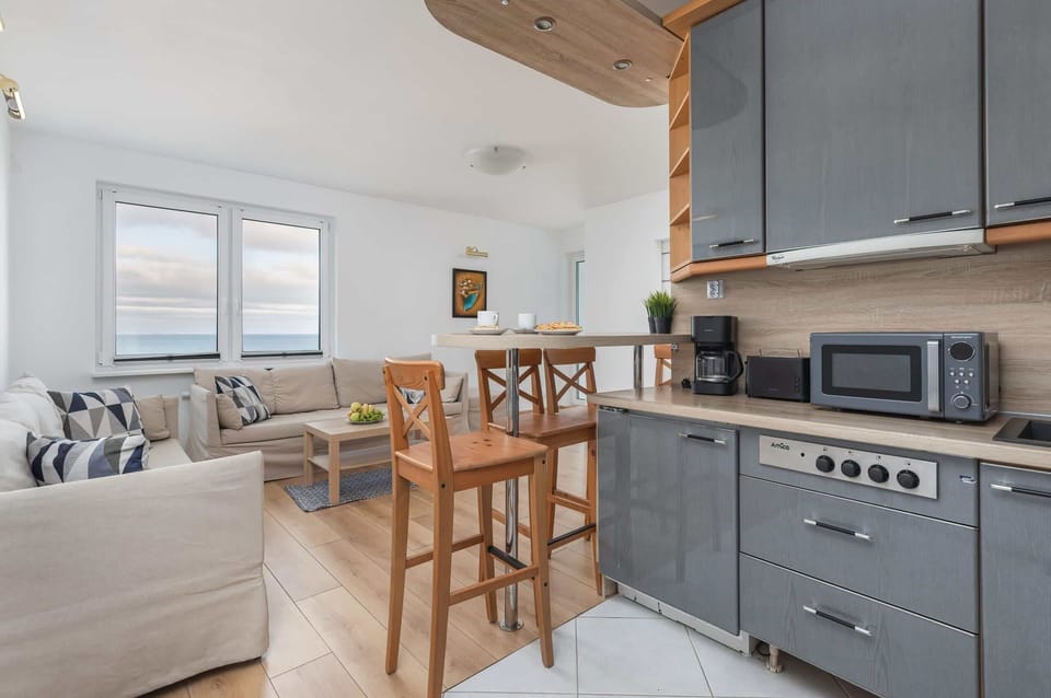 A functional kitchen with modern appliances and wooden accents, perfect for cooking.
