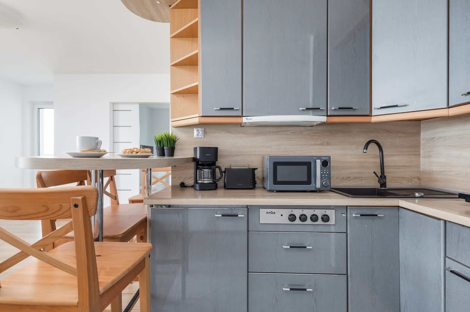 Another angle of the kitchen featuring additional counter space and dining stools.
