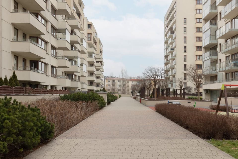 A pathway through the residential area, surrounded by well-maintained gardens.

