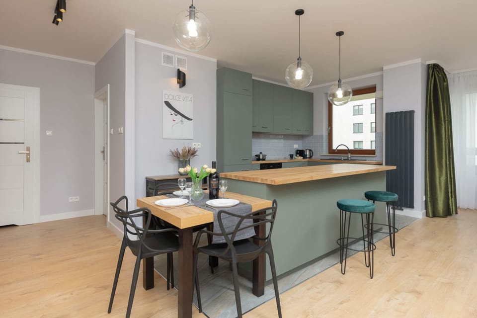 A dining area connected to the kitchen, showcasing a modern table and stylish decor.
