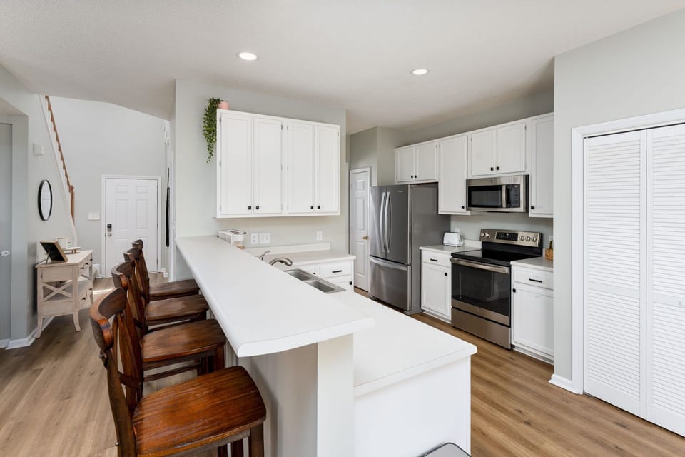 The kitchen is fully stocked with basic cooking supplies and utensils.